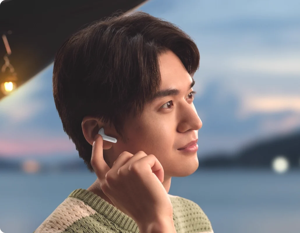 A man touching an earbud