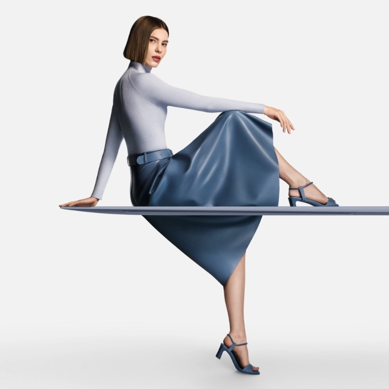 A woman sitting on the blue laptop