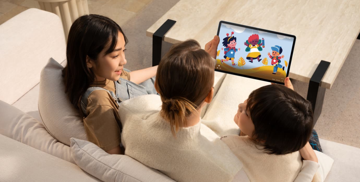 A mother and children watching cartoons on the tablet