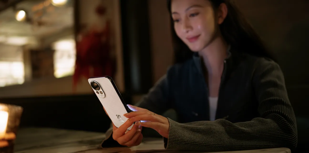 A woman looking at her phone in the evening