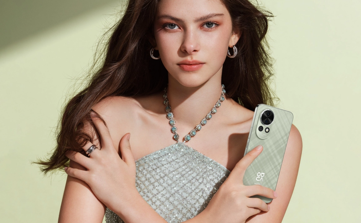 A woman holding HUAWEI nova 13 in Loden Green